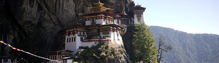 Taktsang Goemba (Tiger's Nest).  This is the most famous monastery and a holy place in all of Bhutan.  Legend says Guru Rinpoche meditated in a cave at this site for three months after he flew here on the back of a tigress to subdue the local demon Singey Samdrup.   Getting to this viewing point and then to the monastery, requires a rigorous trek with a vertical climb of 900m/2952ft above Paro Valley .  The trail head starts at the base of the cliff and winds its way up the mountain.   Then, at 3180m/10,432ft elevation, Tiger's Nest comes into full view at eye-level for the first time.  The sight of it took my breath away and I completely forgot about my labored breath from the hike. It was surreal.  I took this photo with a Panasonic DMC-GF1 camera.  Paro, Bhutan.  October 27, 2012.  - Laurel Pfund 